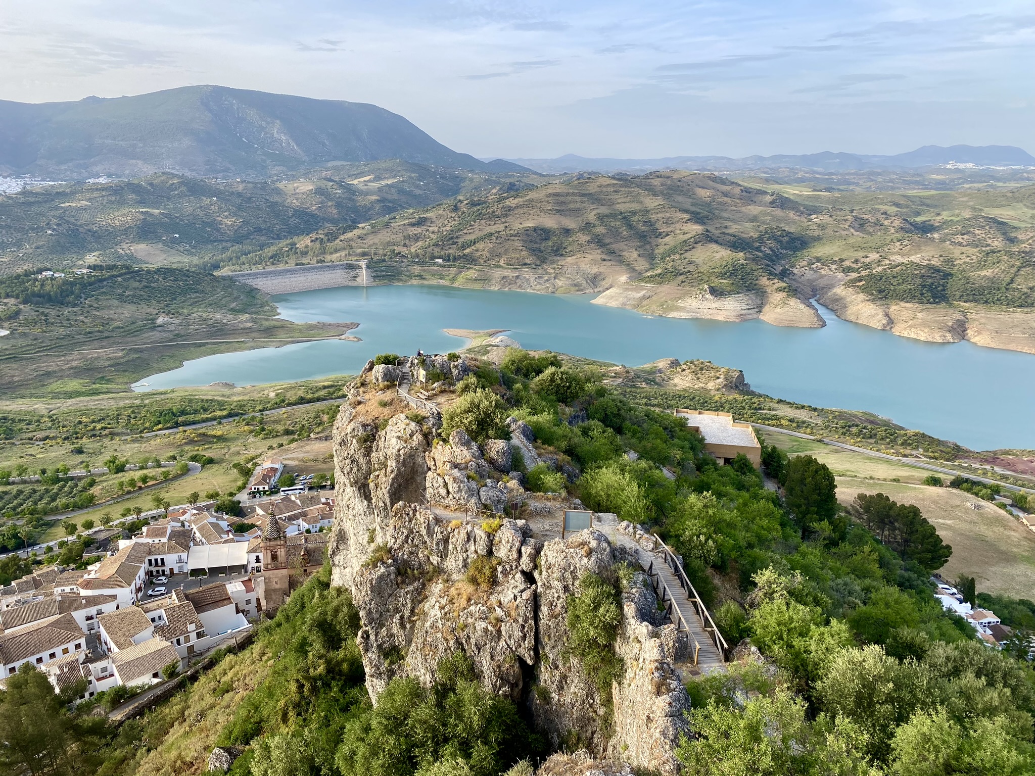 View from the castle of the reservoir, mountains, and village.